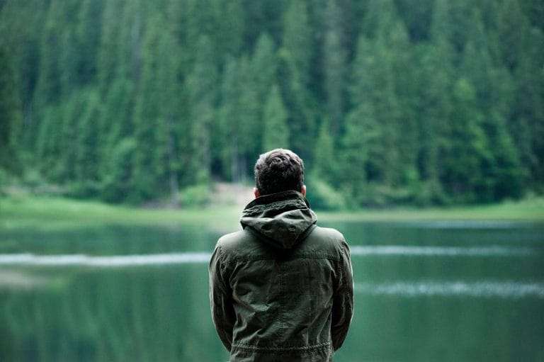 Man feeling bored in forest background due to vitamin deficiency
