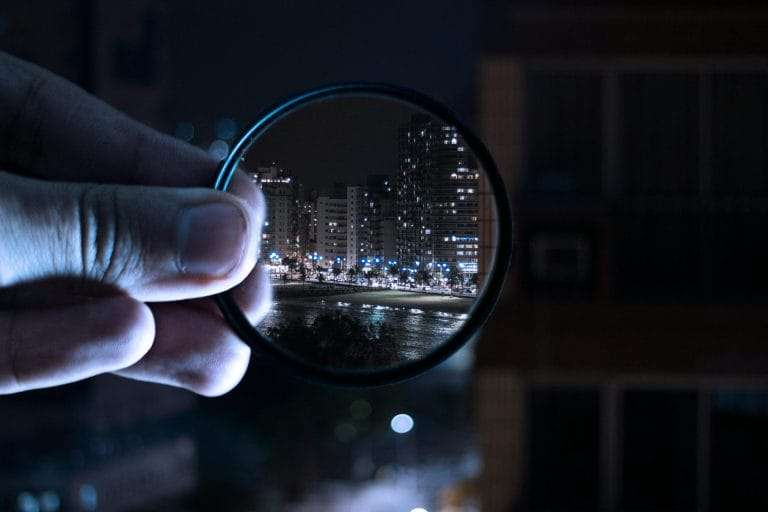 Lens in hand representing to increase focus by using multivitamins