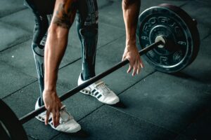 Focused athlete preparing to lift a heavy barbell. Indoor gym setting.