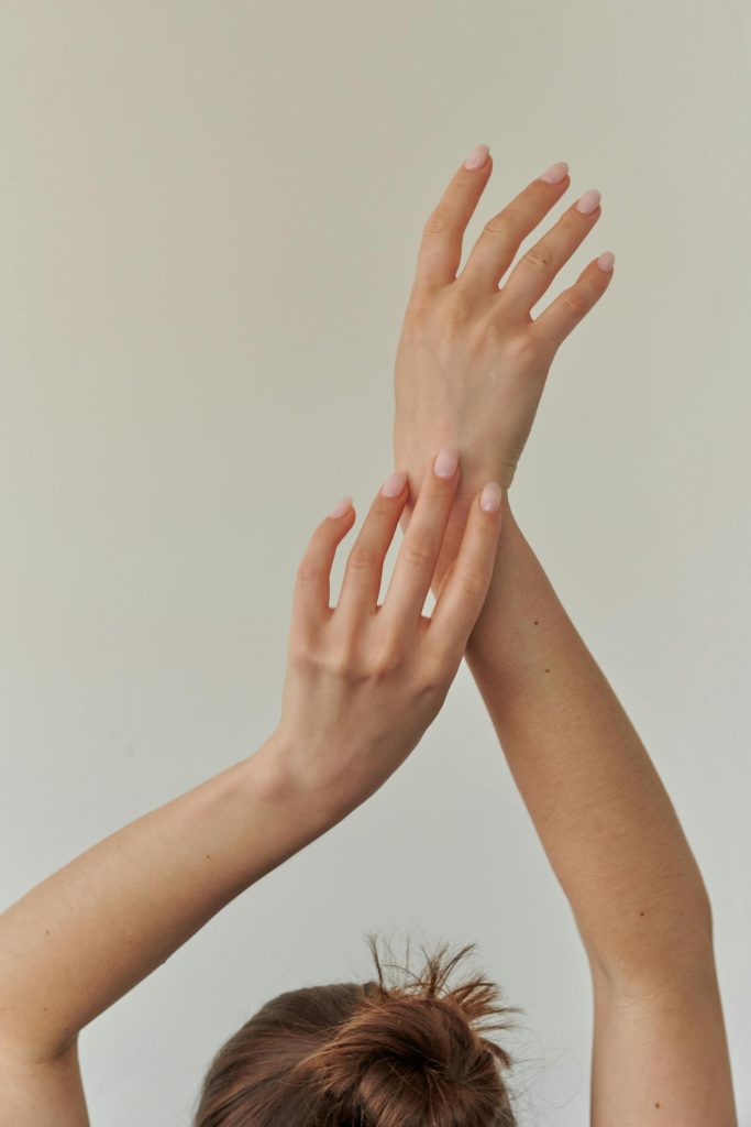 Close-up of a woman's hands elegantly posed, symbolizing elegance and grace.